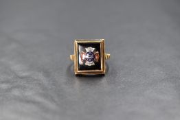 A yellow metal signet ring stamped 10K bearing an enamelled panel regarding the Independent Order Of