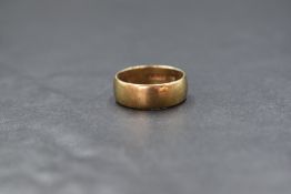 A 9ct gold band, of plain rounded form, marked 375, ring size L-M, 3.6g