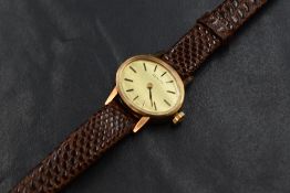 A vintage Zenith wristwatch, the oval golden dial having baton numerals, with personalised