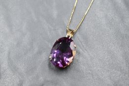 A 14ct gold purple gemstone possibly synthetic alexandrite set pendant, marked 14K, the oval cut