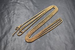 A yellow metal presumed gold snake link muff chain, having a dog clip, 35.4g. Chain is broken