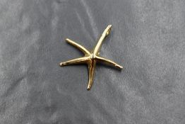 An 18ct gold starfish pendant, the naturalistic starfish having five arms with an applied pendant