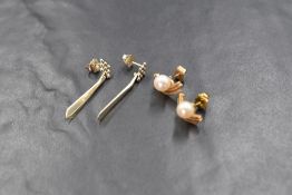 A pair of 14ct white gold drop earrings, having beadwork with articulated drops, engraved 14k (2.