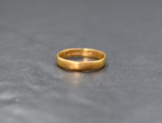 A 22ct gold band, of plain rounded form, marked 22, ring size L, 2.1g