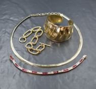 Four pieces of silver gilt jewellery including a cuff bangle, open link bracelet with bar and ring