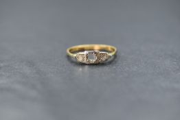 An 18ct gold three stone diamond ring, missing central stone, but two outer mine cut diamonds