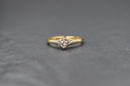 An 18ct gold diamond set solitaire ring, the illusion set round brilliant cut diamond measuring