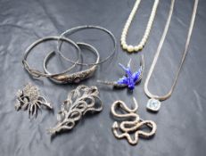 A collection of silver jewellery, comprising marcasite and enamel brooches, bangles, an amethyst set