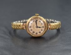 A 9ct gold cased vintage Omega wristwatch, the champagne dial having Arabic numerals, on a rolled