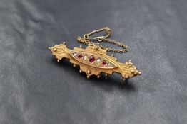 A 9ct gold pearl and pink gemstone set mourning bar brooch, the alternating split pearl and pink