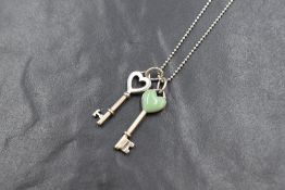 A Tiffany & Co silver bead link chain having two Tiffany key charm pendants, one having turquoise