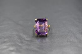 An 18ct gold amethyst set ring, the large emerald cut amethyst measuring approximately 17.7mm x 13mm