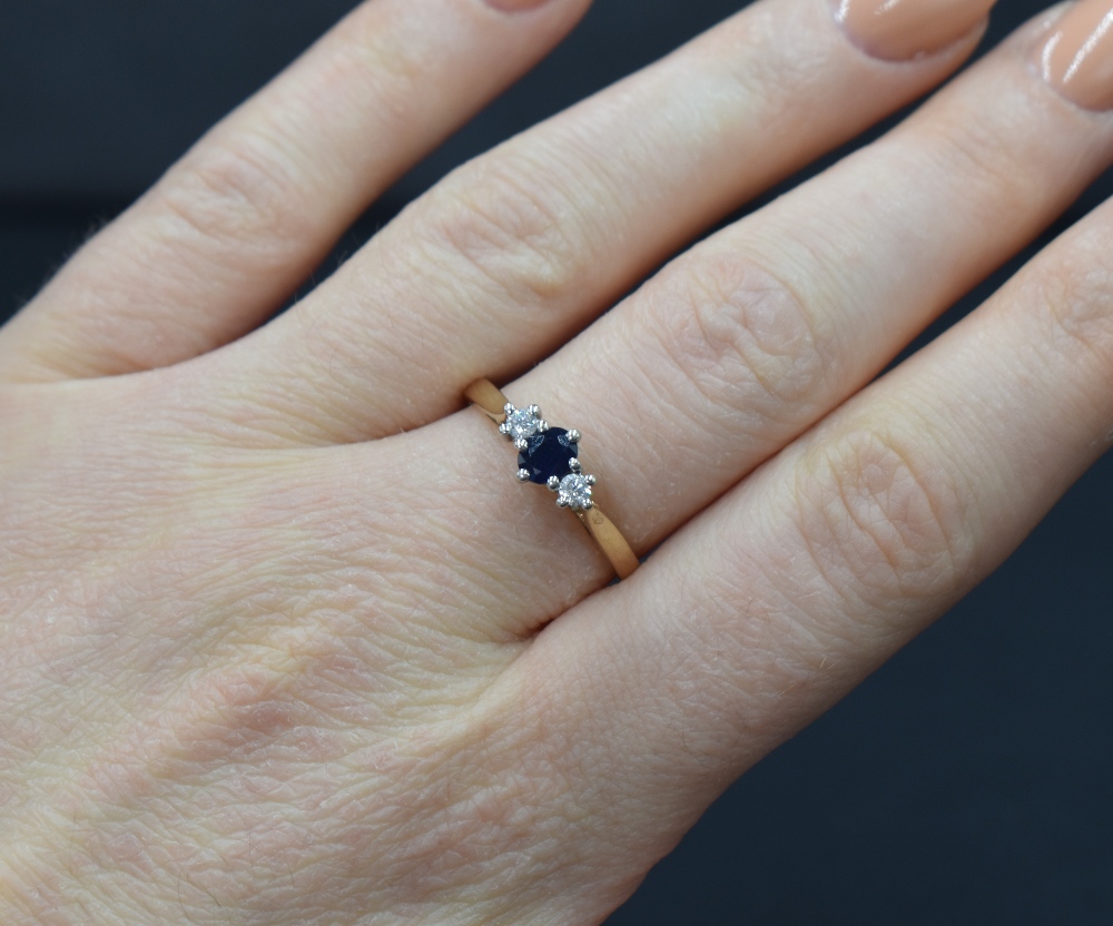 A 9ct gold sapphire and diamond trilogy ring having a central oval sapphire, approx 0.25ct, - Image 3 of 3
