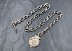 A silver curb link watch chain, having a dog clip and T-bar with a silver medal attached, sterling