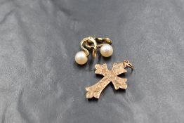 A pair of 9ct gold cultured pearl clip on earrings, the pearls having a white lustre with hinged