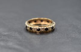 A 9ct gold sapphire and diamond chip set full eternity band, marked 375, ring size N, 3.2g
