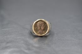 A 14ct white gold coin set signet ring, the imitation Roman coin in a yellow gold bezel setting on a