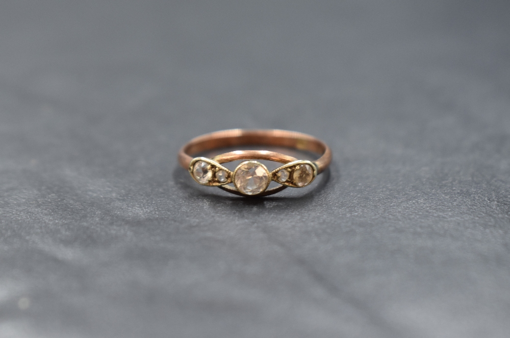 A 9ct gold diamond set five stone ring, the central round cut diamond measuring approximately 0.20ct