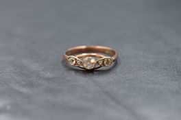 A 9ct gold diamond set five stone ring, the central round cut diamond measuring approximately 0.20ct