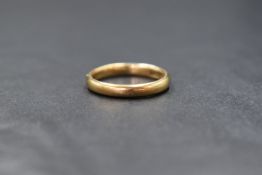 A 9ct gold band, of plain rounded form, marked 375, ring size L-M, 2.6g