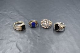 A silver Whitby jet set signet ring, the oval bezel set jet panel with decorative scroll