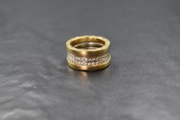 An 18ct gold diamond set Bvlgari band, the two external yellow gold bands flanking two rows of