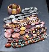 A stackers jewellery tray containing a small selection of modern polished stone costume jewellery