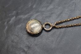 A George IV silver vinaigrette pendant, of circular form having floral decoration and internal