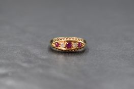 An early 20th Century 18ct gold ruby & diamond ring having three rubies interspersed by two old