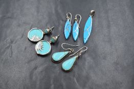 Three pairs of silver and turquoise earrings, one pair having a matching pendant