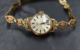 A lady's 9ct gold wrist watch by Avia having a baton numeral dial on pearlised face in a plain