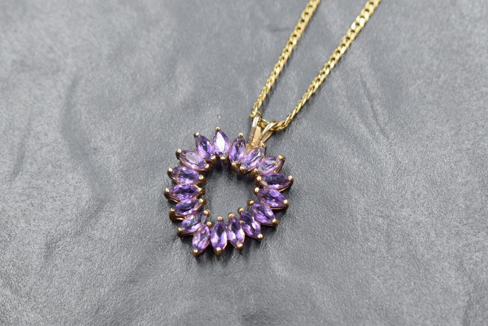 A 9ct gold amethyst open heart pendant with a flat curb link 18' chain, approx 8.3g gross