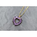A 9ct gold amethyst open heart pendant with a flat curb link 18' chain, approx 8.3g gross