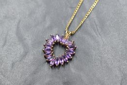 A 9ct gold amethyst open heart pendant with a flat curb link 18' chain, approx 8.3g gross