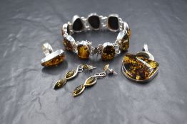 Four pieces of white metal and Baltic amber jewellery of Artisan form, all stamped 925 including
