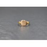 A 9ct gold signet ring, the square panel having 'DW' engraved and 'ML' to reverse, with decorative