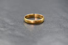 A 22ct gold band, of plain rounded form, marked 22, ring size L-M, 2.4g