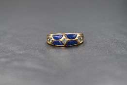 A 9ct gold lapis lazuli and blue topaz set band, the three round cut blue topaz interspersed with