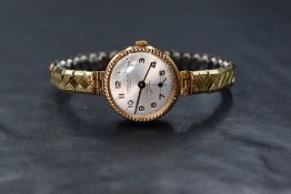 A lady's 9ct gold mechanical wrist watch by Excalibur having an Arabic numeral dial with