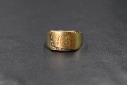 A 14ct gold diamond set signet ring, the rectangular panel having 'AJ' engraved with an illusion set