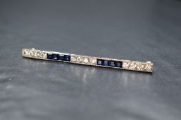An Art Deco platinum, diamond and sapphire bar brooch having twelve brilliant cut diamonds total