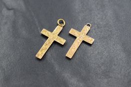 Two small 9ct rose gold hollow cross pendants, both having engraved scroll decoration, no chains,