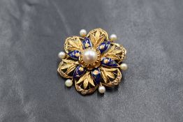 An 18ct gold pearl, enamel and paste set brooch, the central pearl in a floral motif pierced blue