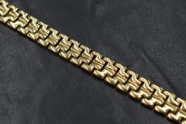 A 9ct gold fancy link bracelet, the articulated links on a box clasp with safety catch, marked