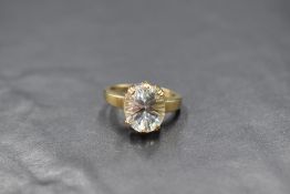 A 9ct gold ring by Gems TV having an oval glacier topaz stone in a raised six claw mount with shaped