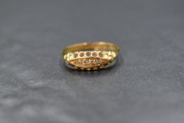 An Edwardian 18ct gold diamond chip set ring, having five small graduated old cut diamonds in a