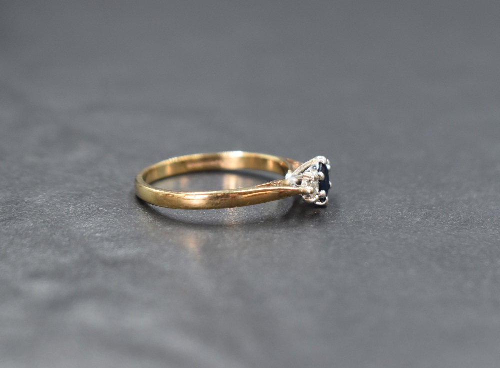 A 9ct gold sapphire and diamond trilogy ring having a central oval sapphire, approx 0.25ct, - Image 2 of 3