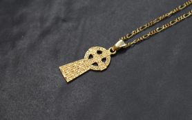 A 9ct gold Celtic cross pendant, having decorative engraving, on a 9ct gold figaro chain, marked