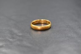 A 22ct gold band, of plain rounded form, marked 22, ring size Q, 4.9g