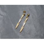 A pair of white and yellow metal articulated drop earrings with post fittings and butterflies